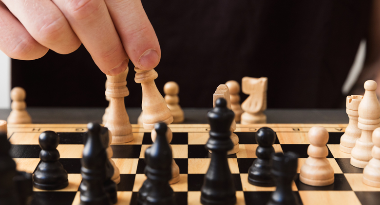 An employee plays chess during leadership training
