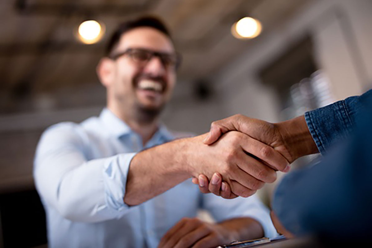 middle aged man shaking hands with recruiter